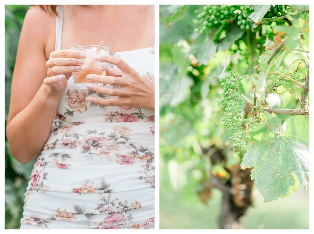 A woman in a floral dress holding a rosé popsicle in a wine glass in front of lush vines at Newport Vineyards