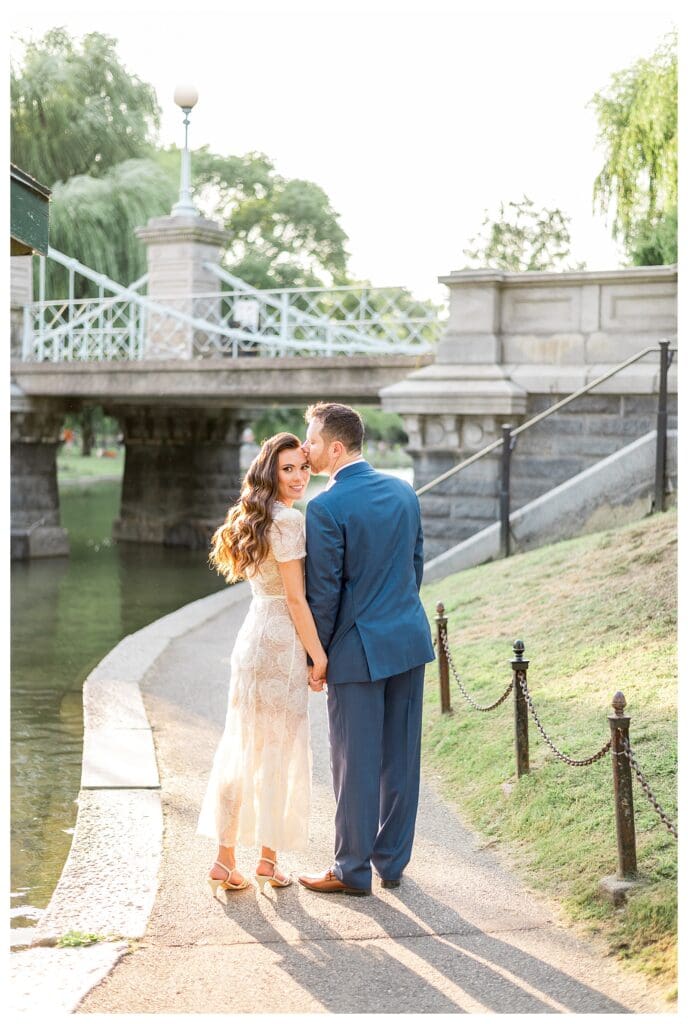 Romantic moment captured in front of the Boston Public Garden Bridge.