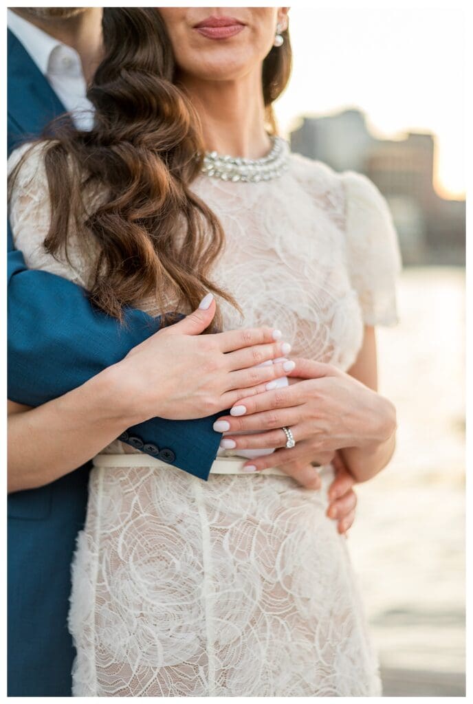 Close-up of couple’s hands with wedding bands.