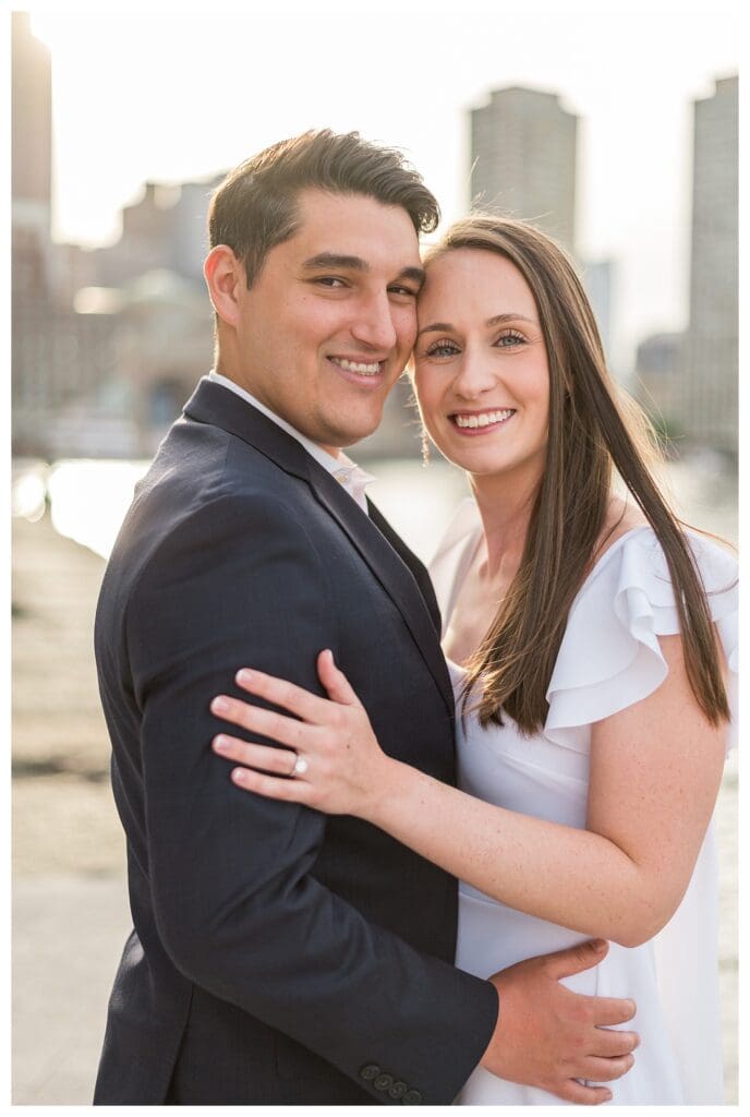 Couple embracing on the Boston Seaport pier.