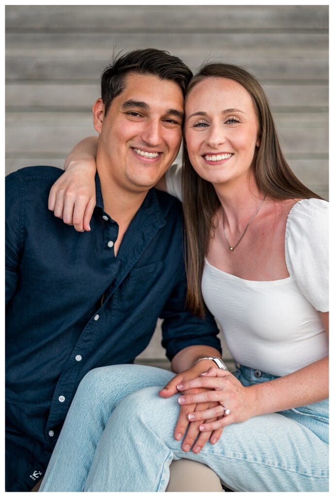 Couple sitting together on ICA steps in the Boston Seaport.
