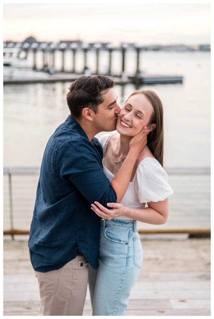 Playful moment as he kisses her on the cheek.