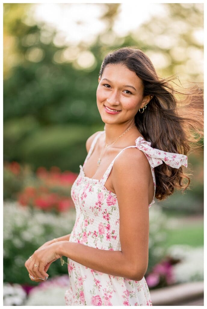 Close-up of senior girl’s soft smile at golden hour.