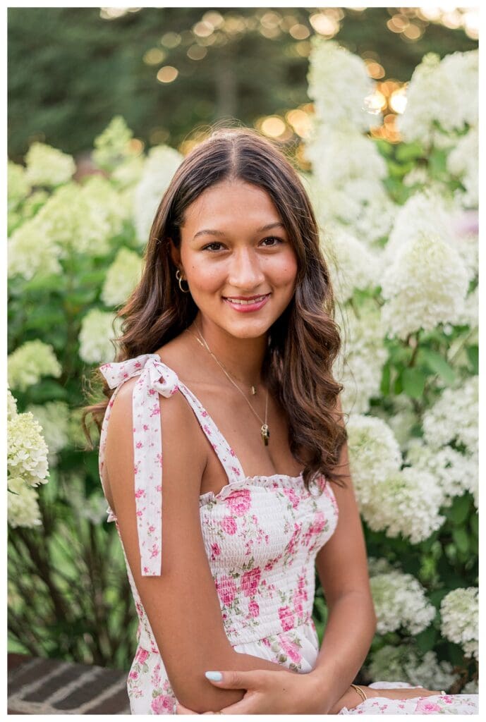 Izzy standing among white hydrangeas at Lynch Park.