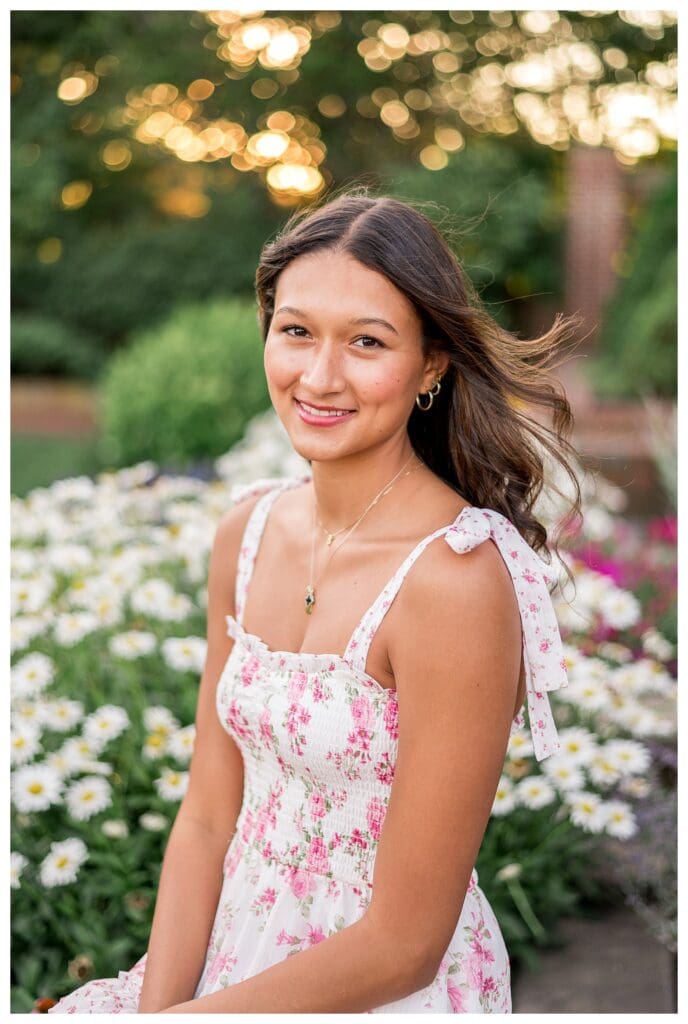 Soft golden tones highlight Izzy’s hair and floral dress.