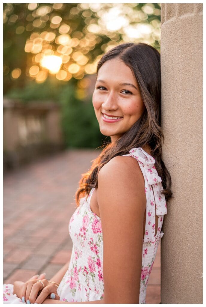 Portrait of Izzy looking over her shoulder in golden sunlight.