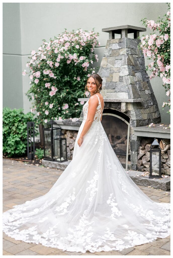 Bride, Noelle Lambert showing off her lace train while getting ready on the wedding morning.