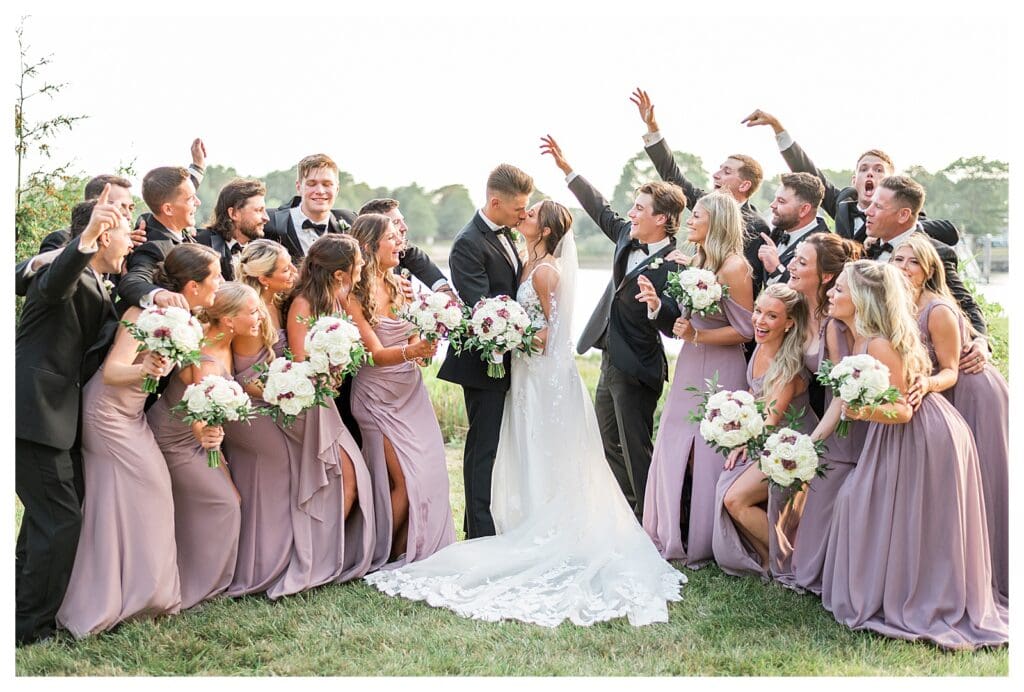 Wedding party cheering and celebrating outdoors.
