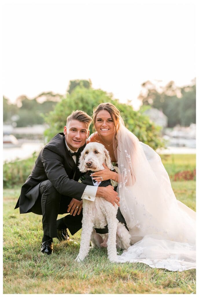 Dog sitting between the bride and groom during wedding portraits.