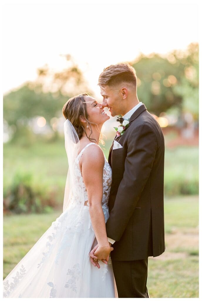 Bride and groom sharing a kiss in their wedding portraits.