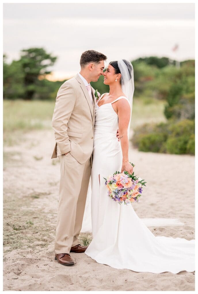 Newlyweds embracing during golden hour portraits at Wychmere.