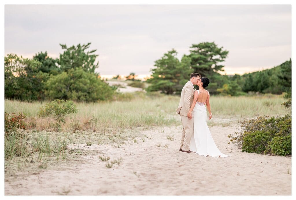 Bride and groom on sandy beach at Wychmere Beach Club