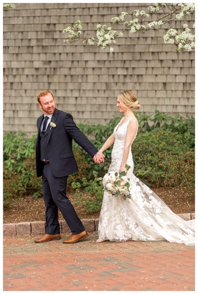 Bride and groom walking at Cape Cod wedding venue.