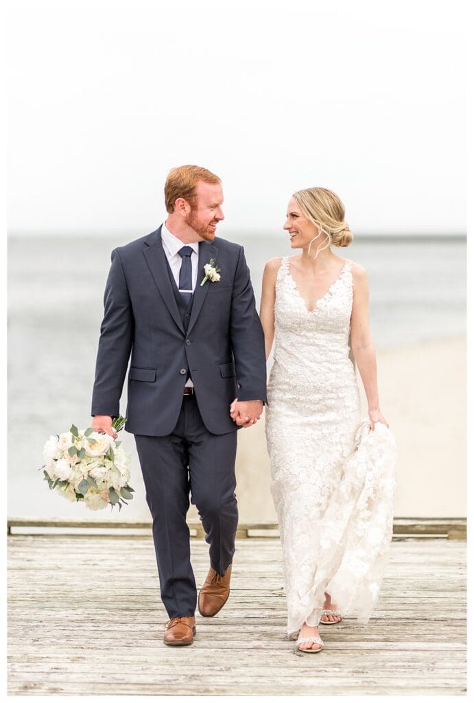 Couple smiling on boardwalk leading to Wychmere beach.