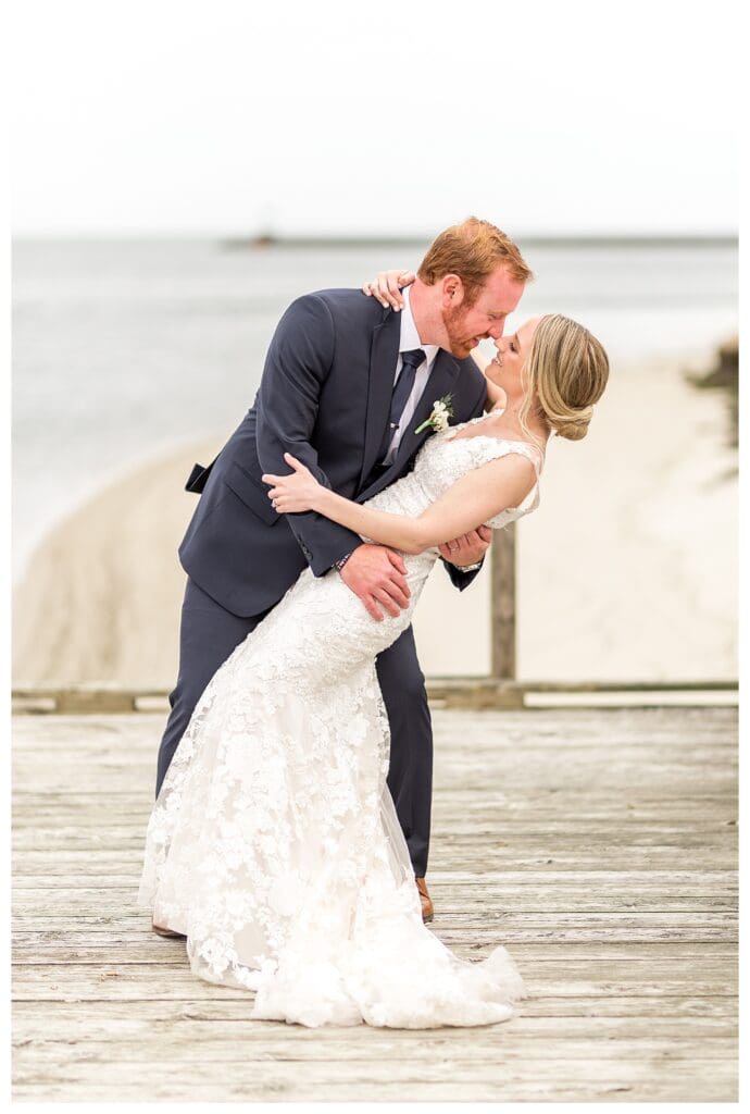 Newlyweds do a dip along Wychmere boardwalk.