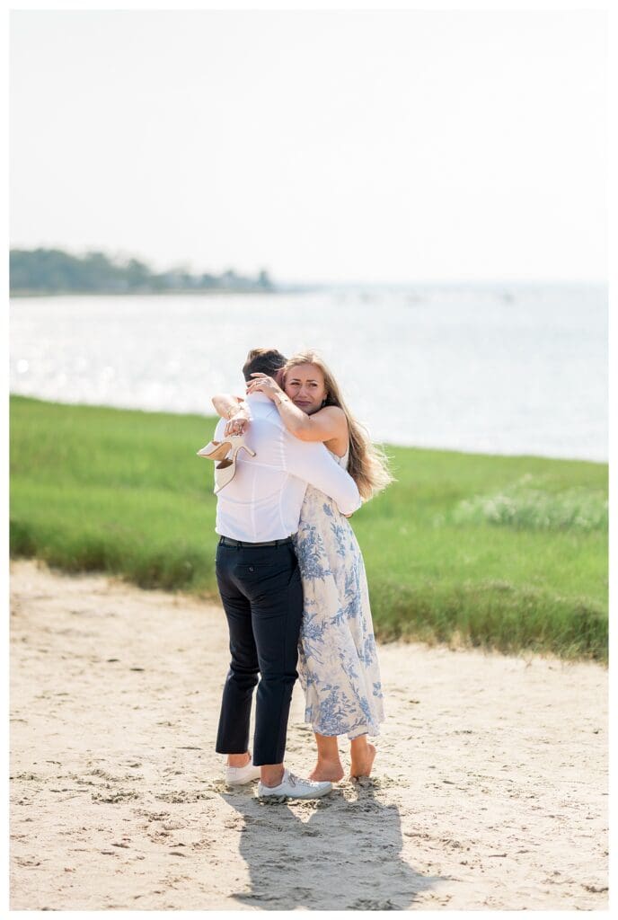 Emotional portrait of Reid and Libby embracing during their Yarmouth proposal