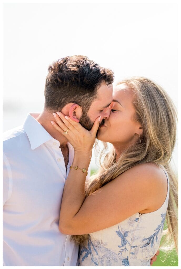 Reid kissing Libby as she shows off her engagement ring on the Yarmouth shoreline
