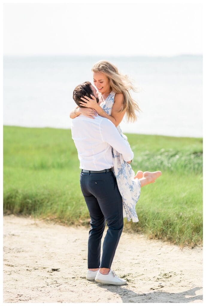Candid laughter as Reid lifts Libby during their Yarmouth Cape Cod proposal session
