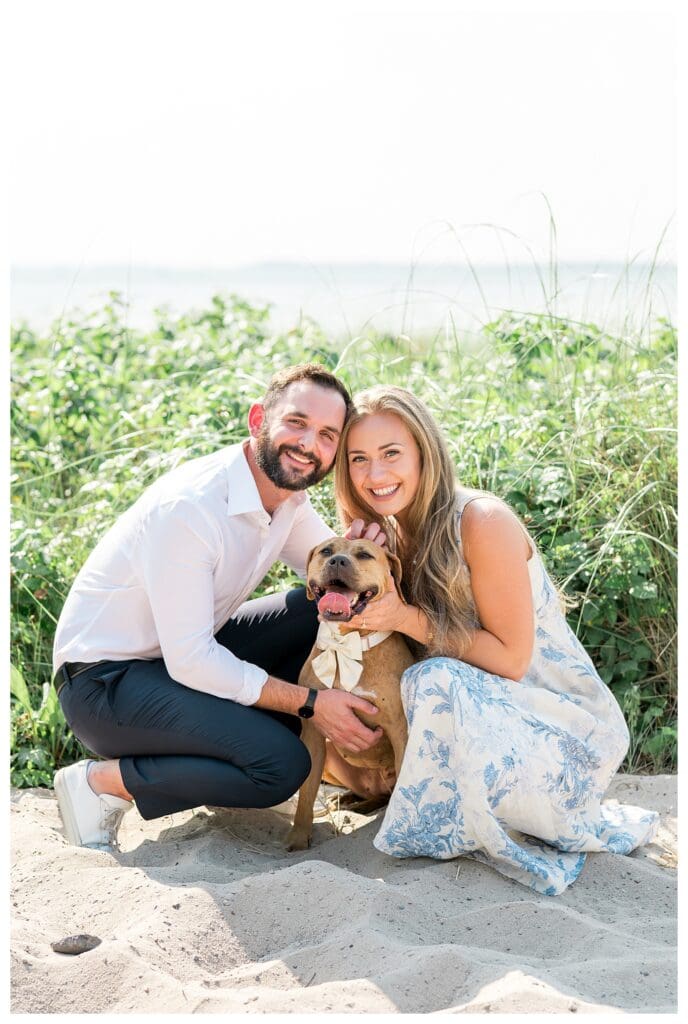 Reid and Libby kneeling with their dog Marmalade during their Cape Cod proposal photos