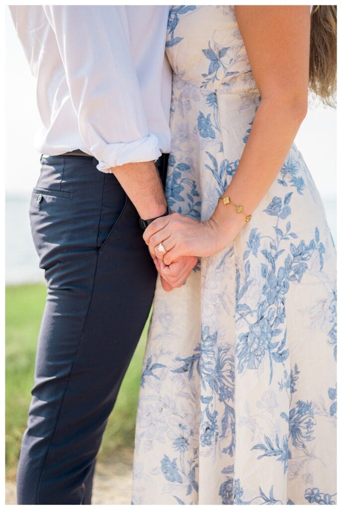 Engagement ring close up while Libby & Reid hold hands