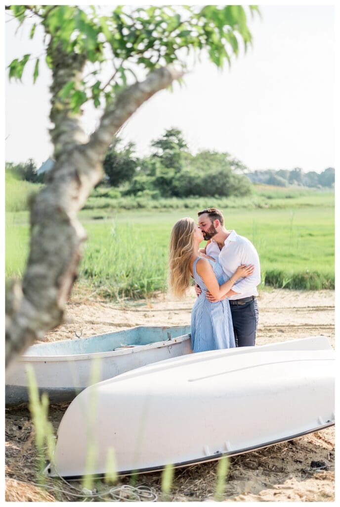 Reid and Libby sharing a kiss with Cape Cod marshlands in the background