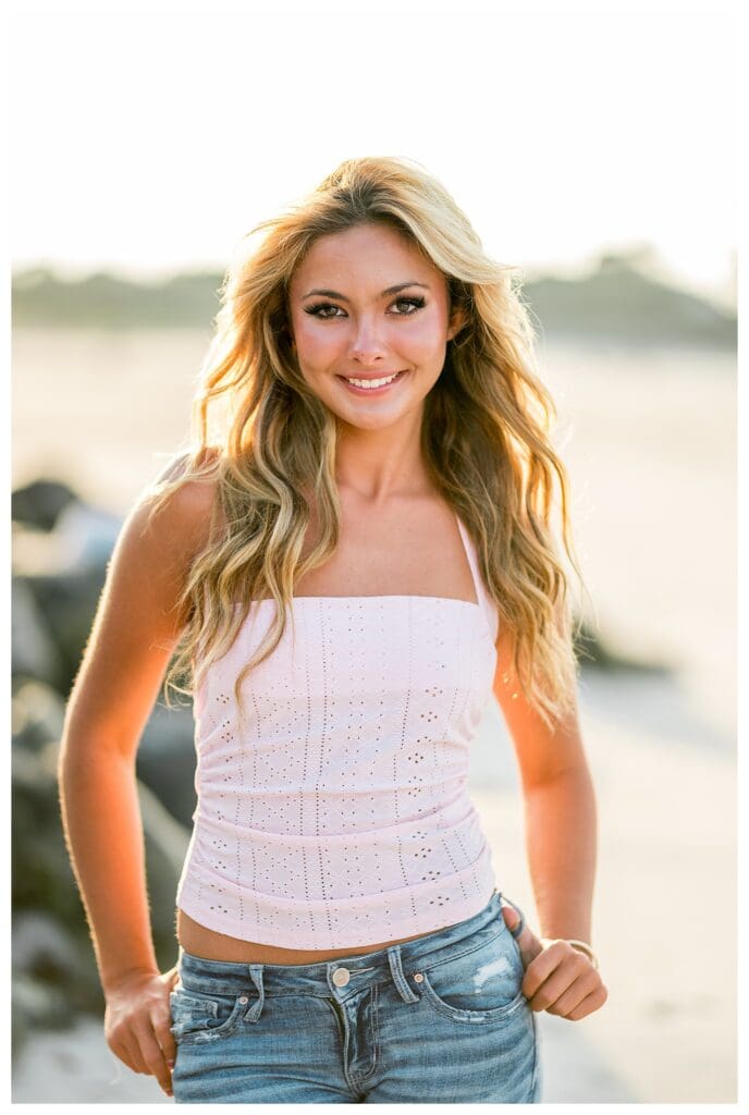 Senior girl smiling during a coastal photo session in Cohasset, Massachusetts