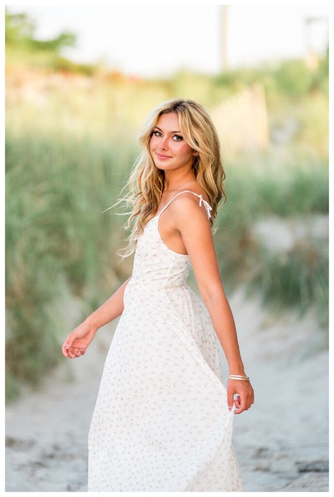 High school senior twirling in the sand during a Cohasset beach photo session