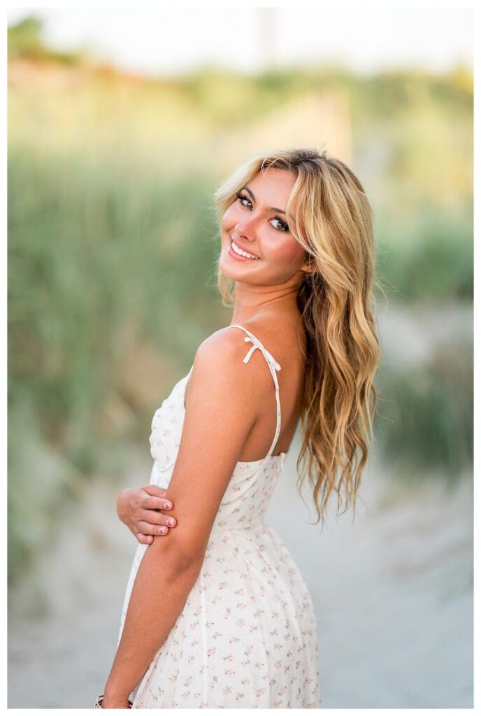 Senior girl laughing during her beach photo session in Cohasset, Massachusetts