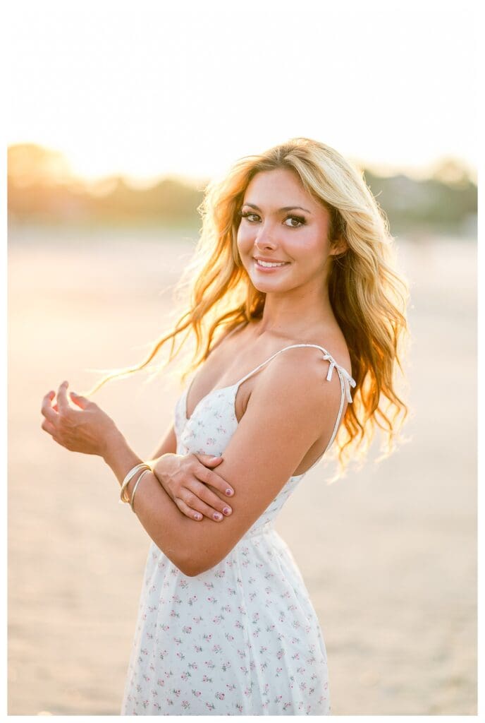 Glowing beach senior portrait taken at sunset in Cohasset, MA