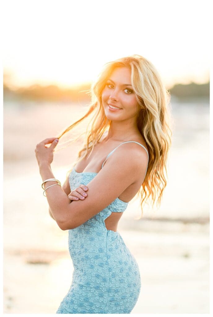 Golden hour senior portrait featuring beach and water views in Cohasset