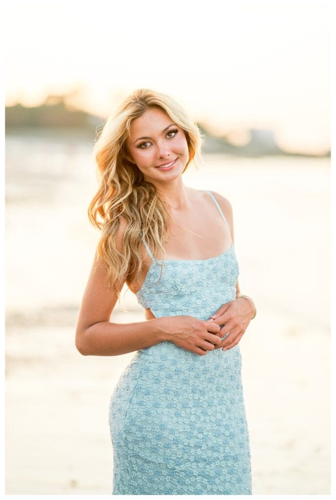 Senior portrait at the beach in Cohasset with warm sunset tones