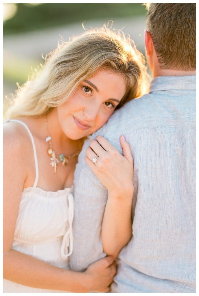 Romantic portrait of Jess resting on Jamie’s shoulder at The Knob in Falmouth, MA
