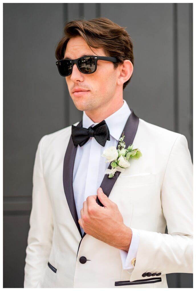 Groom in a white tuxedo jacket during an elegant California winery wedding