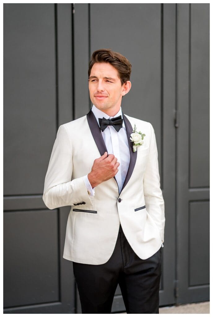 Groom holding his lapel during stylish Monserate Winery wedding day