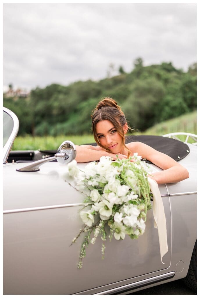 Classic getaway car parked near vineyards at Monserate Winery destination wedding