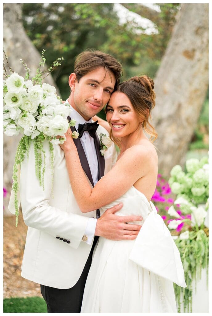 Bride and groom embracing during a romantic Monserate Winery wedding surrounded by vineyards in Southern California