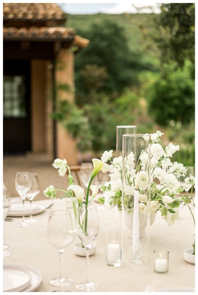 Wedding table design with white florals and glassware at a luxury Monserate Winery reception