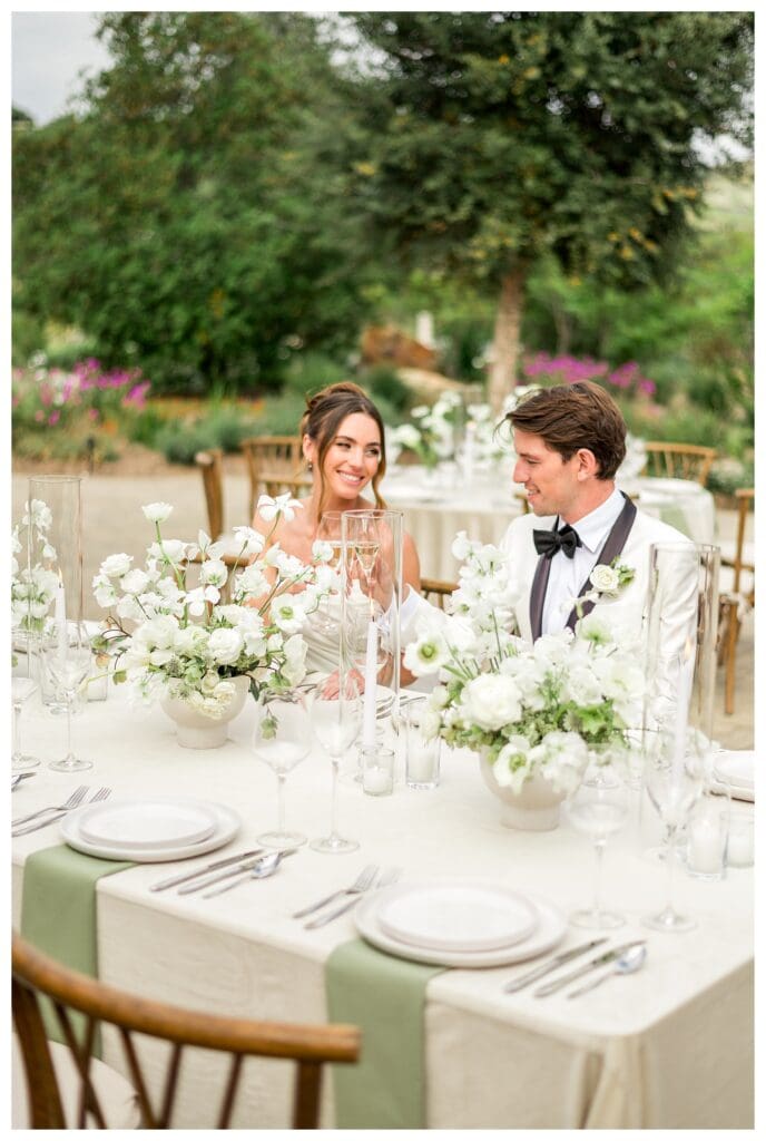 Bride and groom seated together at reception table during Monserate Winery wedding