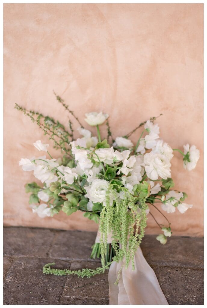 Close-up of cascading bridal bouquet featuring white blooms and greenery at California wedding