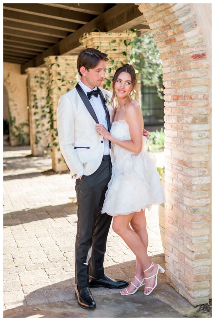 Joyful wedding couple under archway in North San Diego County