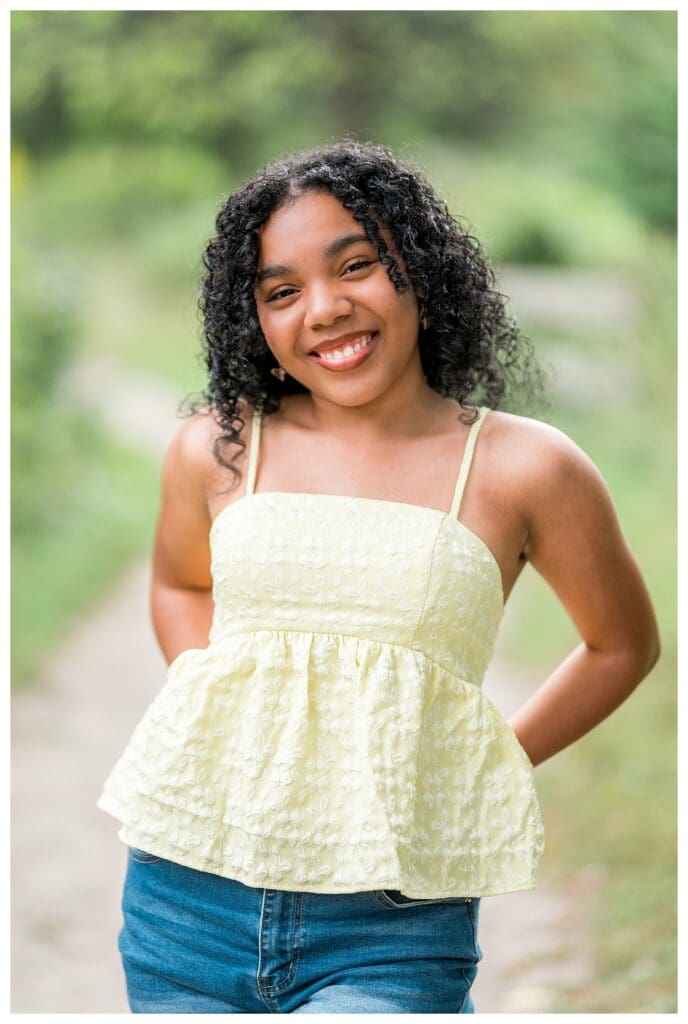 Close up Andover High Senior portrait with soft natural light and relaxed smile at Acton Arboretum.