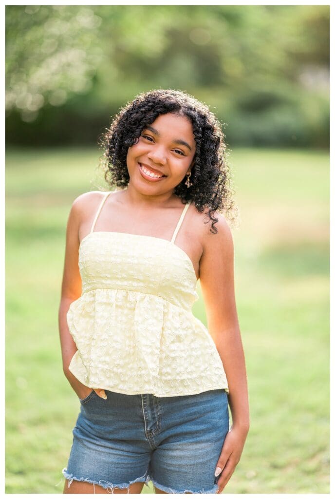 Close up senior headshot with soft bokeh background at Acton Arboretum.