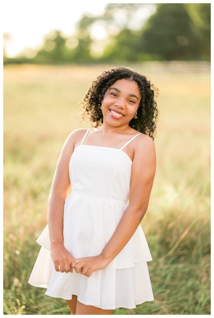 Bright outdoor portrait of Andover High School senior smiling with confidence.
