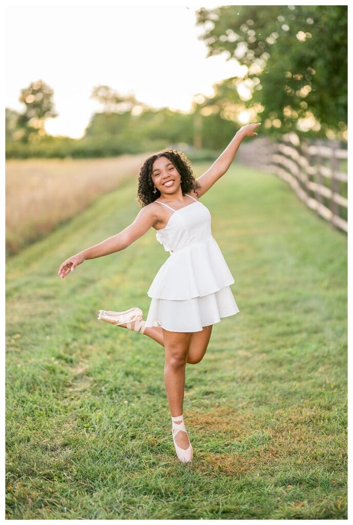 Dance inspired senior portraits featuring pointe shoes and flowing white dress.