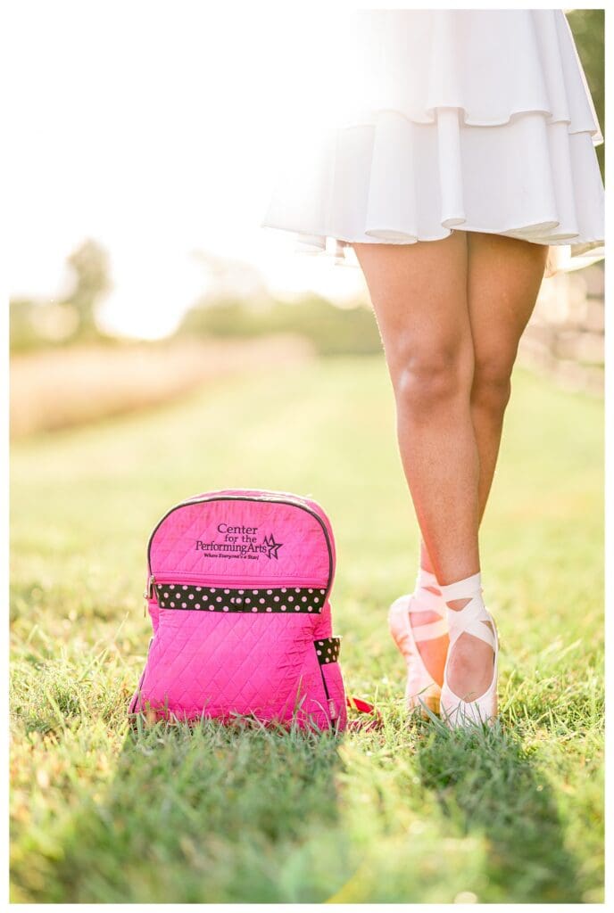 Creative senior portrait blending ballet passion with outdoor scenery.