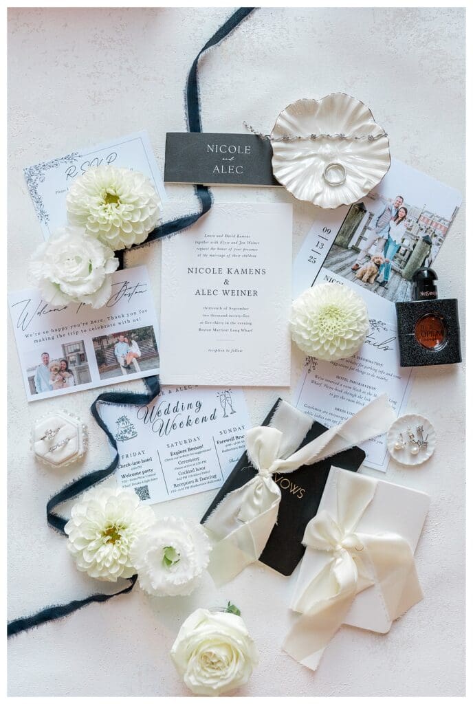 Wedding detail flat lay with invitations and rings at Boston Marriott Long Wharf.