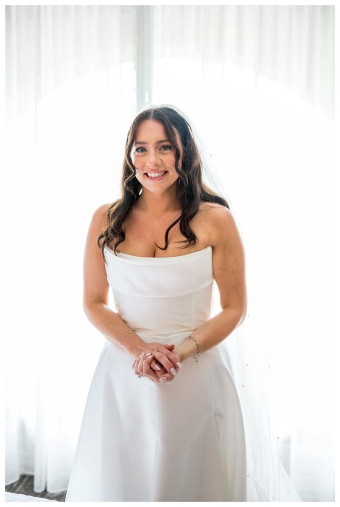 Bride getting ready at Boston Marriott Long Wharf with natural window light.