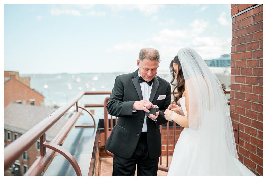 Emotional father daughter first look on balcony at Boston hotel wedding.