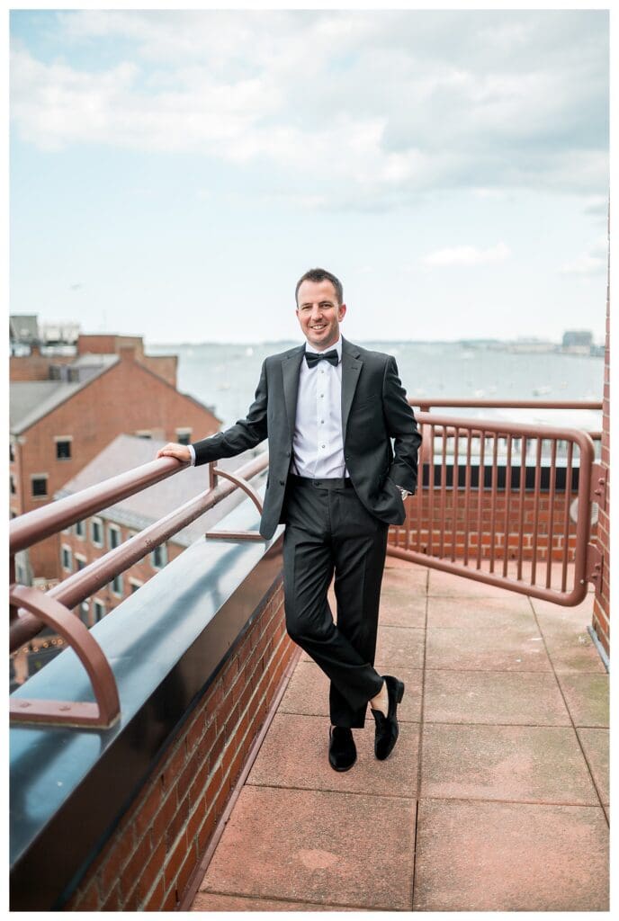 Waterfront Boston Wedding, groom portrait with skyline views.