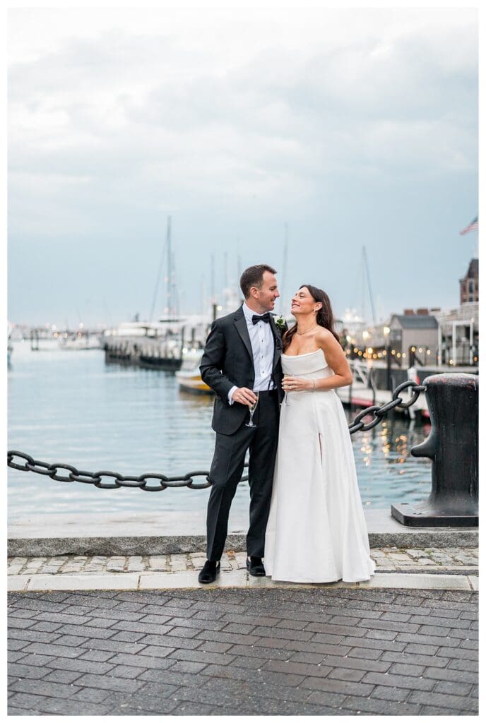 Classic Boston harbor wedding portrait with brick walkway.